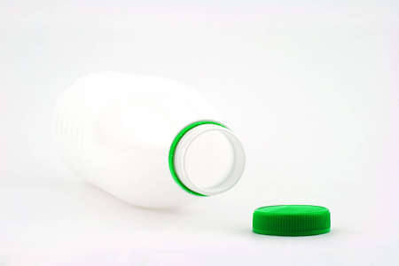 Photo of white bottle with green cover on white backgroundの写真素材