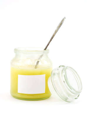 Isolated photo of a honey-jar with blank and teaspoonの写真素材