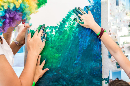 Children draw with their fingers on canvasの写真素材