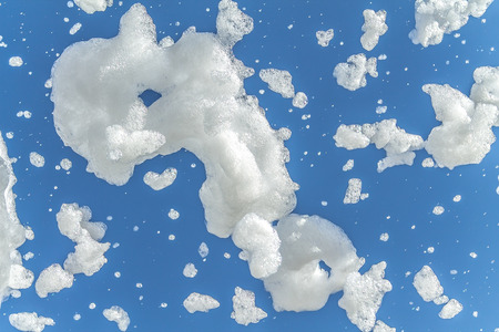 Soap foam against the sky background as a backgroundの写真素材