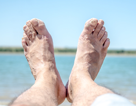 Feet in the mud on the beachの写真素材