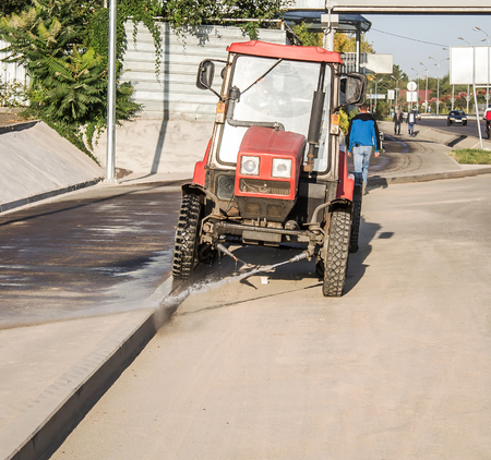 Tractor washes road in the cityの写真素材