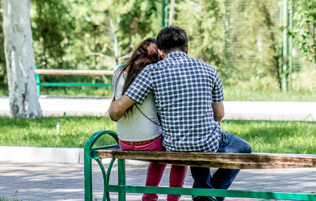 A guy with a girl in the park on a benchの写真素材