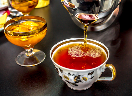 Pours tea into a cupの写真素材