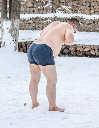 Stripped man in the snowの写真素材