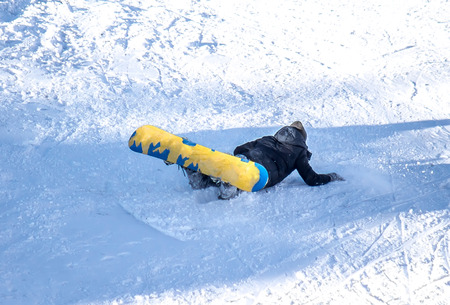 Falling skier on the mountainside at the ski resortの写真素材