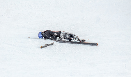 Falling skier on the mountainside at the ski resortの写真素材