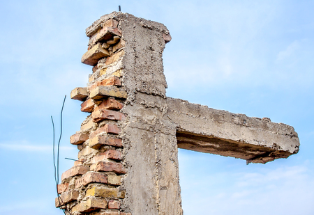 The destroyed brick column against the skyの写真素材