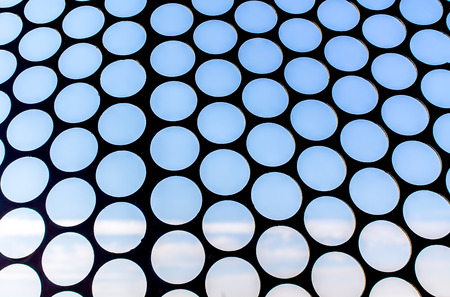 Metal grille against the skyの写真素材