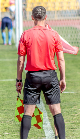 Shymkent, Kazakhstan, March 17, 2018; Football match at the stadium.Champion of the Republic of Kazakhstan between the teams "Ordabasy" Shymkent - "Kyzyl Zhar" Petropavlovsk. A side judge with a flag.のeditorial素材