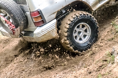 Car wheel in the dirt and water