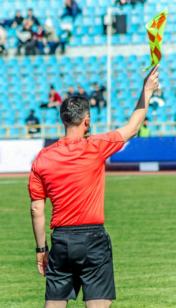 Shymkent, Kazakhstan, March 17, 2018; Football match at the stadium.Champion of the Republic of Kazakhstan between the teams "Ordabasy" Shymkent - "Kyzyl Zhar" Petropavlovsk. A side judge with a flag.のeditorial素材