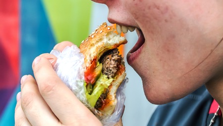 A man eats a burgerの写真素材