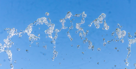Fountain spatter on the sky background as a backgroundの写真素材