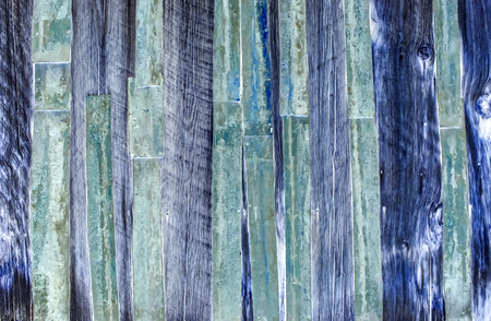 Old wooden fence with rusty metal as background inversionの写真素材