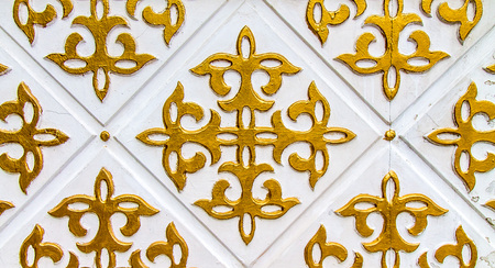 Kazakh ornament gold on white on the wallの写真素材