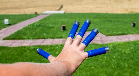 A man holds cartridges for a gunの写真素材