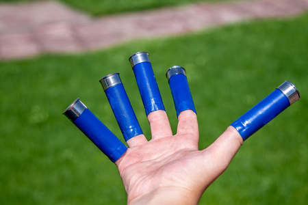 A man holds cartridges for a gun