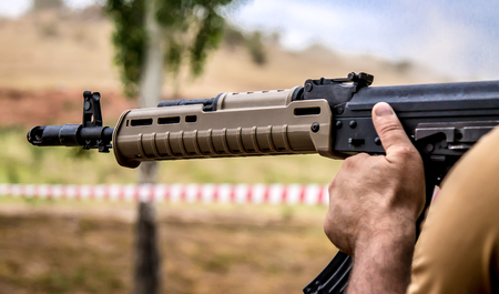 A man shoots a machine gun