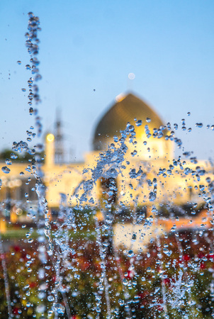 Spray fountain on urban buildings backgroundの写真素材