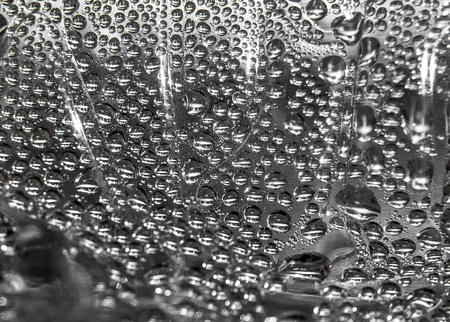 Water drops on glass as an abstract background.の写真素材
