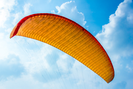 Paraglider in the air against the skyの写真素材