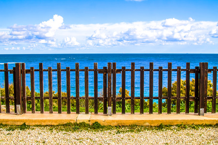 The fence on the background of the sea landscapeの写真素材