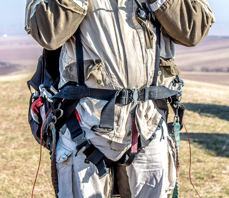 Paraglider prepares to fly in the open air.Parachute in the backpack outdoorsの写真素材