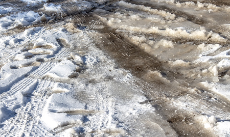 Broken dirt road in winterの写真素材