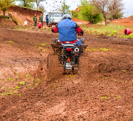 Dirt from under the wheels of a motorcycle close-up