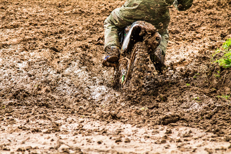 Dirt from under the wheels of a motorcycle close-up
