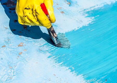 Painting the surface with blue oil paint brushの写真素材