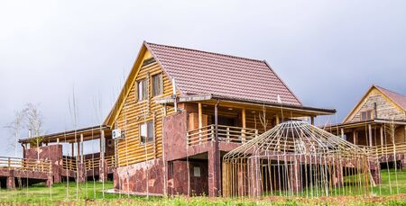 Wooden houses for rest on the background of spring mountains. The concept of country rest. Ecology and unity with nature.の写真素材