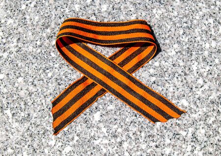 Victory Day. St. George ribbon on a stone plate. The symbol of Russian military glory and victory in the Great Patriotic War.の写真素材