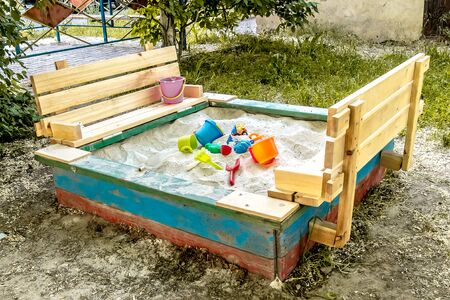Children's colored plastic toys in the sandboxの写真素材