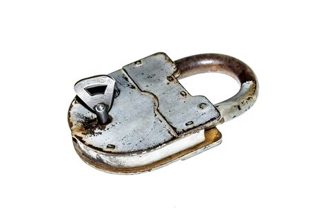 Old padlock with key on white backgroundの写真素材