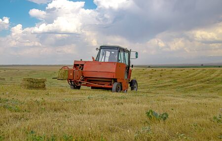 Grass collection by pick-up for livestock feed. Rural landscapeの写真素材