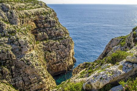 Rocky coast is washed by the sea in Malta. Blue Lagoonの写真素材
