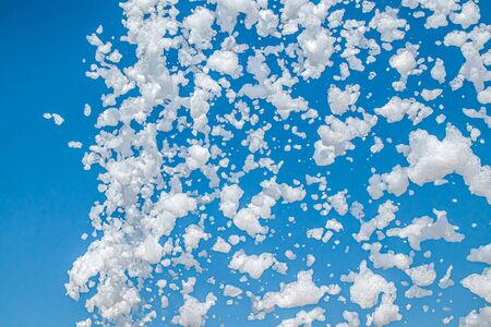 Soap foam on the background of blue sky as a background for design. Atmosphere of a holiday and summer outdoor recreation.の写真素材