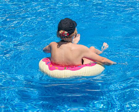 Girl swims in the pool. Resort relaxationの写真素材