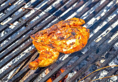 Chicken thigh is grilled outdoorsの写真素材