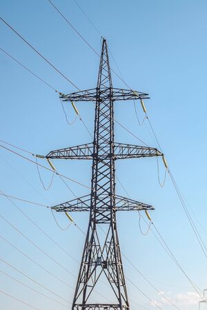Metal pylons of high-voltage power lines against the skyの写真素材