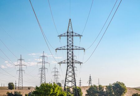 Metal pylons of high-voltage power lines against the skyの写真素材