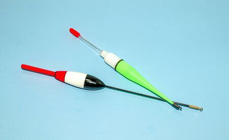 Tackle for catching fish float on a blue background. Fishing. Active rest and hobby. Sale of fishing gear in the store.の写真素材