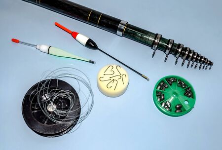 Tackles for catching fish on a blue background. Fishing. Active rest and hobby. Sale of fishing tackles in the store.の写真素材