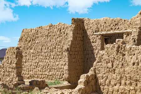 The destroyed walls of the building of clay against the sky. The walls of the ancient city of Otrar in Asiaの写真素材