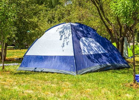 Tent under the trees. Wild outdoor recreation.の写真素材
