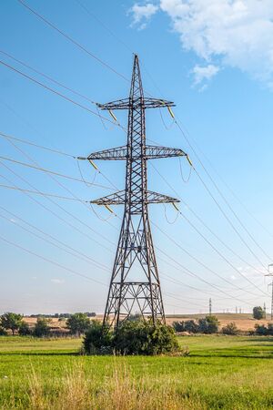 Metal pylons of high-voltage power lines against the skyの写真素材