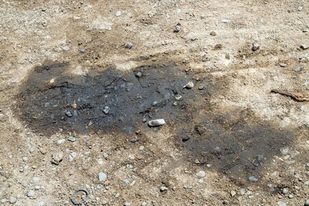 Spilled motor oil on the ground. Ecological catastrophy