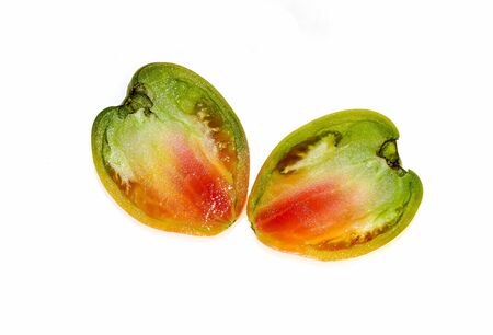Red-green tomato isolated on white background close-upの写真素材